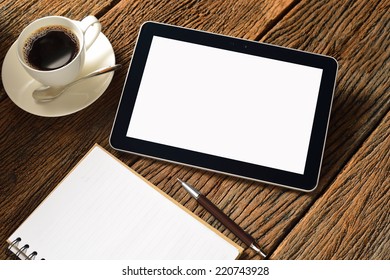 Tablet computer with notepad and coffee cup on old wooden background - Powered by Shutterstock