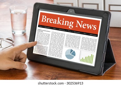 A tablet computer on a desk - Breaking News