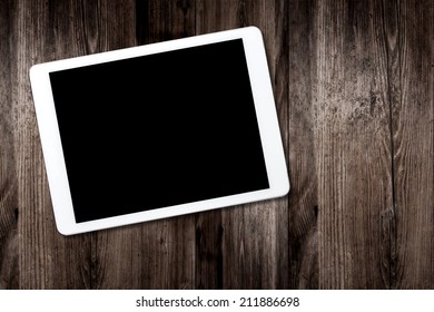 tablet computer on old wooden table