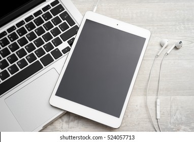 Tablet computer on the table with earphone - Powered by Shutterstock