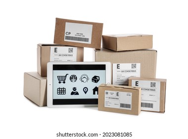 Tablet computer with open page of delivery service application and parcels on white background