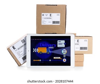 Tablet computer with open page of delivery service application and parcels on white background