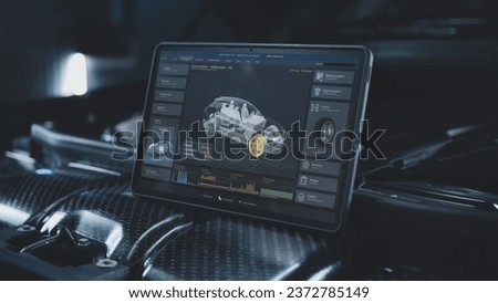 Tablet computer screen shows 3D animation of professional program for real-time car diagnostics and aerodynamics testing using 3D virtual electric vehicle model. Concept of car developing technology.