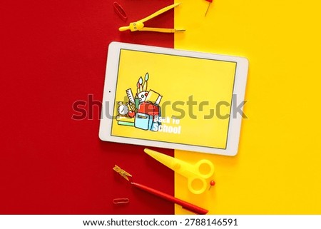 Tablet computer with text BACK TO SCHOOL and stationery on color background