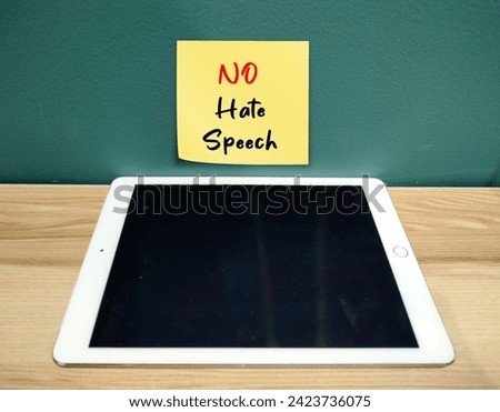 Tablet computer with text written reminder NO HATE SPEECH , concept of banning hate speech, no more spread hate on social media platform on internet or real life