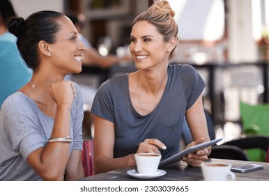 Tablet, discussion and women drinking coffee at a cafeteria together talking and scrolling on social media. Happy, smile and friends speaking, laughing and enjoying a capuccino at restaurant in city.