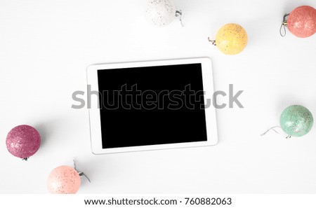 tablet display on table Christmas composition background. wallpaper, pine cones, decoration balls, on whit