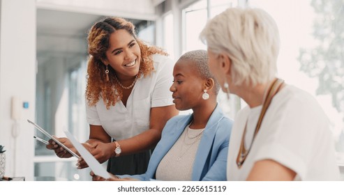 Tablet, documents and teamwork of business women discussing sales, advertising or marketing data. Paperwork, tech and group of business people with touchscreen planning strategy in office workplace. - Shutterstock ID 2265615119