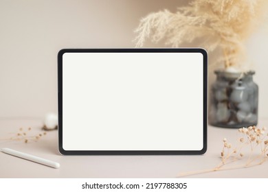 Tablet empty white screen with pencil mock-up. Cotton flower and dry leaves on beige background mockup for design - Shutterstock ID 2197788305