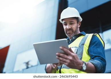 Tablet, engineer and man with helmet on construction site for development or building in city on project. Male person, tech and architecture as manager for progress in industrial, design and safety - Powered by Shutterstock