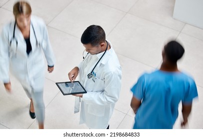 Tablet, Healthcare And Medicine With A Man Doctor Working In A Busy Hospital With Urgency. Medical, Research And Insurance With Professional Workers In Medicine Rushing With Blur In A Clinic