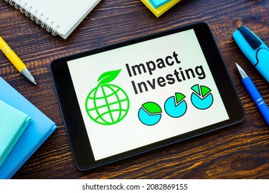 Tablet With Impact Investing Info And Notebooks.