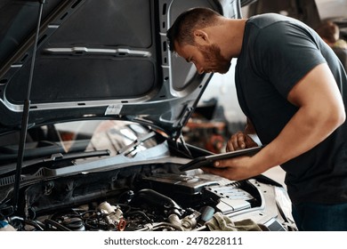 Tablet, inspection and mechanic in workshop with car service, maintenance or online auto insurance. Tech, engine and man in garage with digital app for checklist, motor repair and quality assurance - Powered by Shutterstock