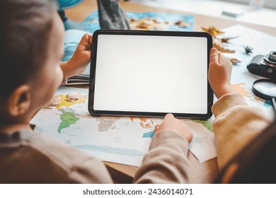 Tablet with isolated screen in child's hands, studying geography concept. - Powered by Shutterstock