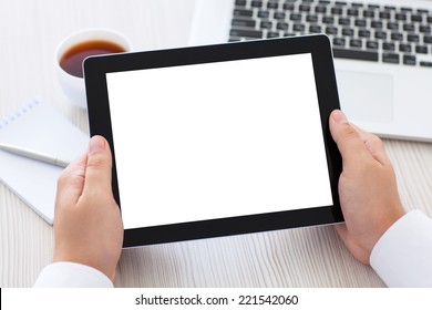 tablet with isolated screen in male hands over the table in the office