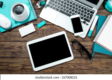 Tablet, laptop, desk.