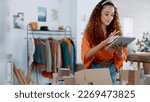 Tablet, logistics and fashion manager with a checklist in retail store clothes or clothing boxes inspection. Entrepreneur, shopping and small business owner writing stock delivery for quality control