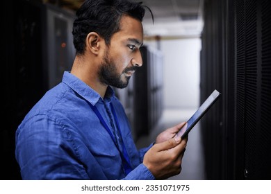 Tablet, man and reading in server room of technician programming at night. Information technology, focus and engineer in data center, cybersecurity network or coding software of system admin research - Powered by Shutterstock