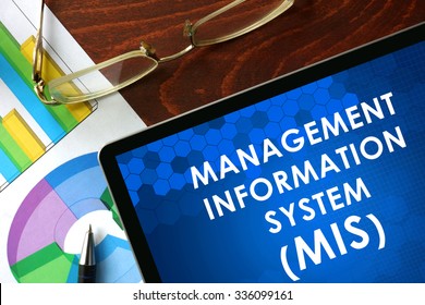 Tablet With Management Information System (MIS) On A Table. Business Concept.