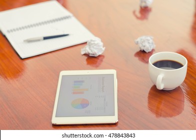 tablet and notepad on desk
