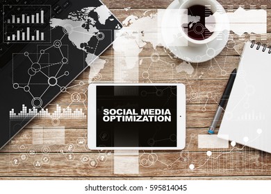 Tablet On Desktop With Social Media Optimization Text.