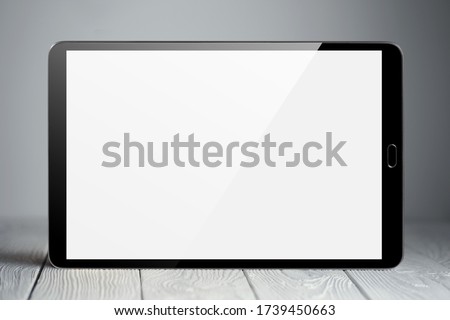 Tablet on neutral gray background