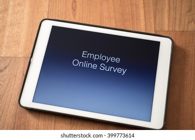 Tablet On Table With Online Employee Survey