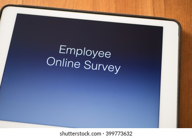 Tablet On Table With Online Employee Survey
