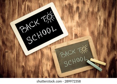 Tablet PC and blackboard on wooden desk in class. Education concept. Top view - Shutterstock ID 289972358