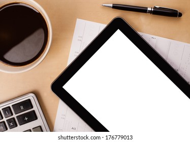 Tablet pc with copy space and a cup of coffee on a wooden work table close-up