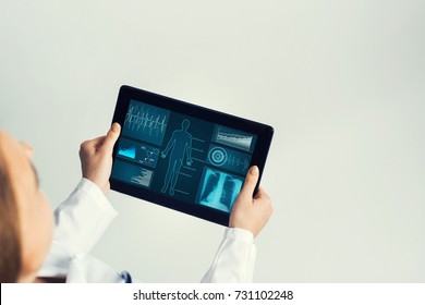 Tablet pc device with medicine interface screen in hands of doctor