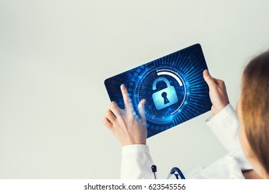Tablet pc device with security padlock on screen in hands of doctor