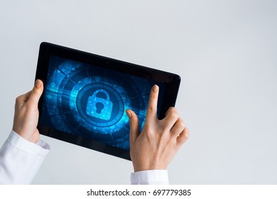 Tablet Pc Device With Security Padlock On Screen In Hands Of Doctor