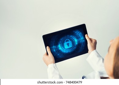 Tablet pc device with security padlock on screen in hands of doctor