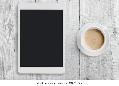 Tablet Pc Looking Like Ipad Mini On Table With Coffee Cup 