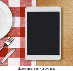 Tablet Pc Looking Lioke Ipad On Dinner Table With Fork And Knife