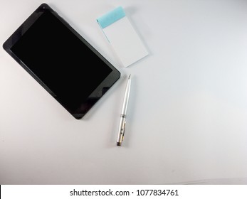Tablet pc, note pad and pen White background
