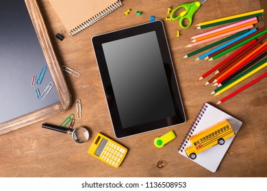 Tablet pc, notebook stack and pencils. Schoolchild and student studies accessories. Back to school concept.