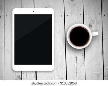 Tablet pc on table with coffee cup