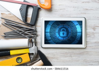 Tablet pc with security concept on screen and industrial tools around