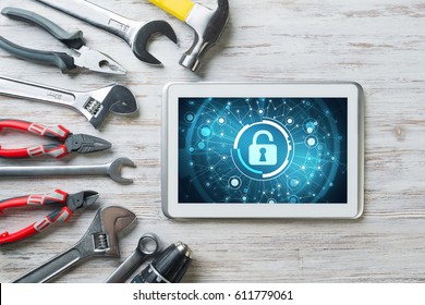 Tablet pc with security concept on screen and industrial tools around