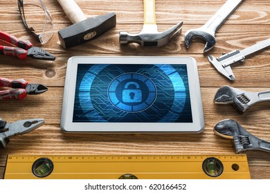 Tablet pc with security concept on screen and industrial tools around