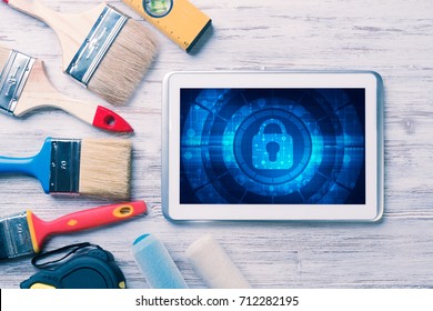 Tablet pc with security concept on screen and industrial tools around