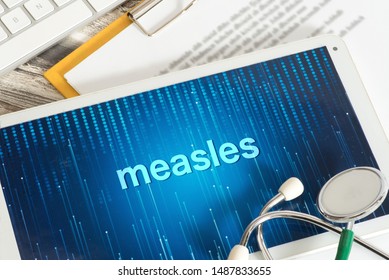 A Tablet Pc, Stethoscope And Warning Of The Measles