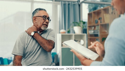 Tablet physiotherapy and senior patient for consultation with shoulder pain, injury and assessment in office. Doctor, physiotherapist and elderly man with muscle help, service and digital technology - Powered by Shutterstock