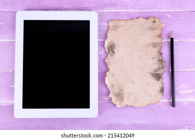 Tablet, piece of paper and pencil on wooden background