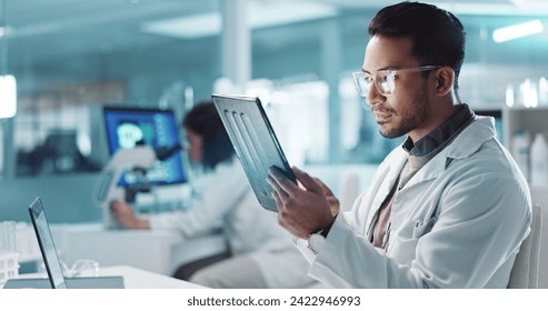 Tablet, scientist and happy for analysis in laboratory, healthcare and reading of online pharmaceutical research. Asian expert, technology or connection for innovation or information in biotechnology