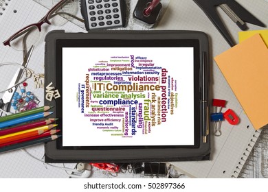 Tablet screen with IT compliance word cloud shaped as a circle