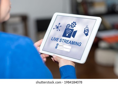 Tablet screen displaying a live streaming concept - Shutterstock ID 1984184078
