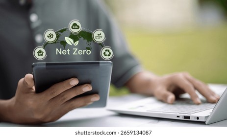 Tablet screen showing net zero text with earth and eco icons, illustrating global technology in climate change solutions.